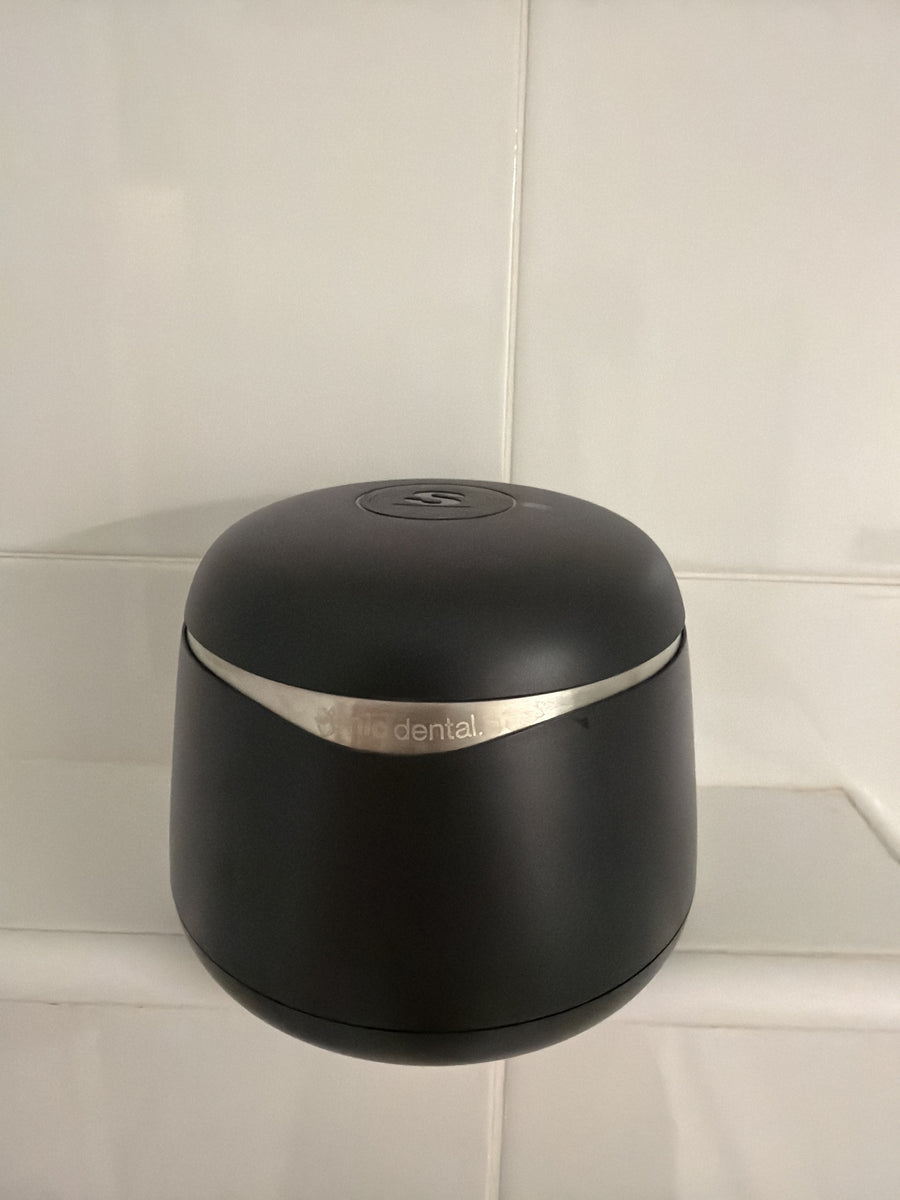 Customer photo of a black Sonic Pro cleaner against a light tiled wall
