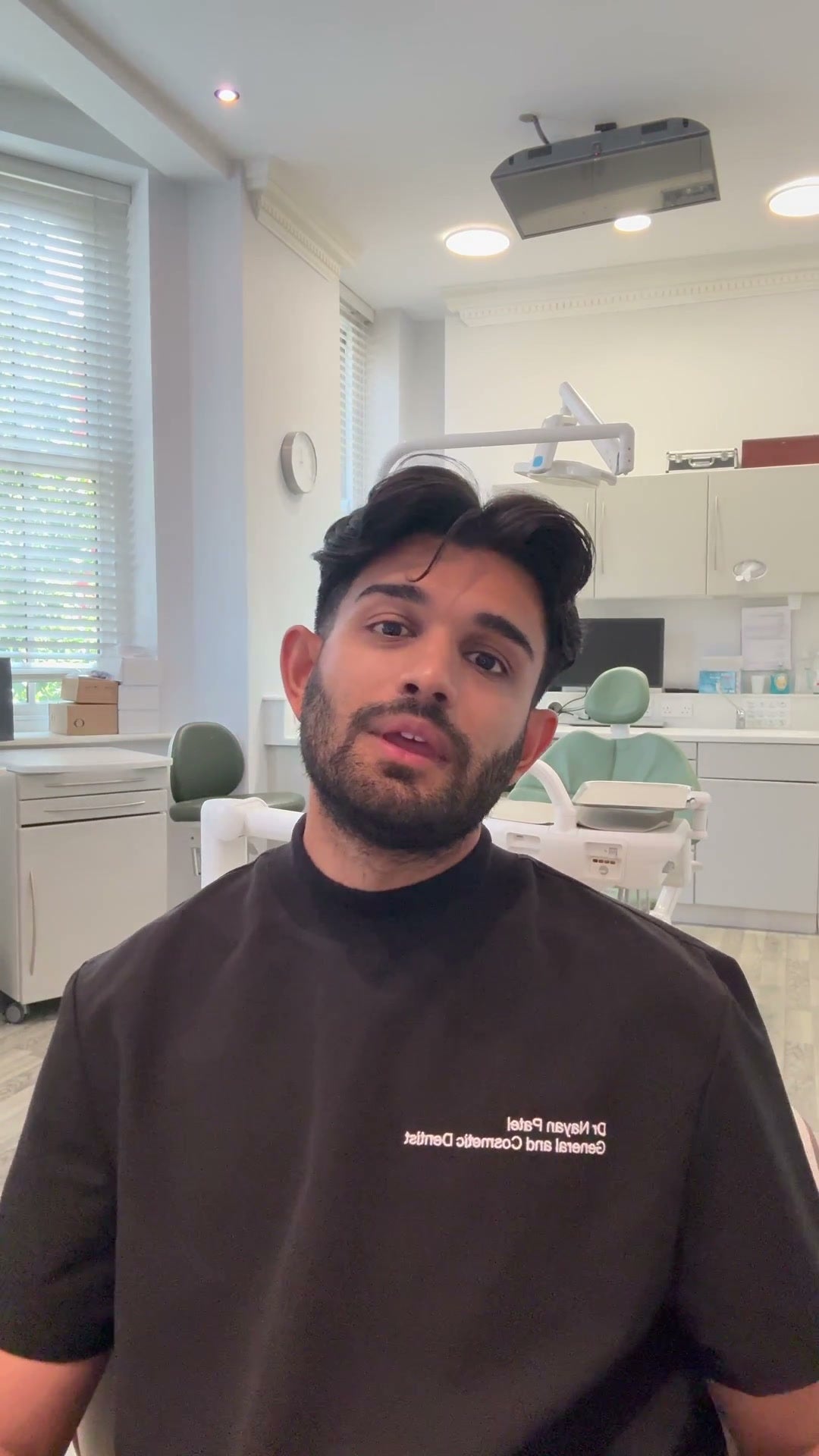 Dr Nayan Patel speaking in their dental practice
